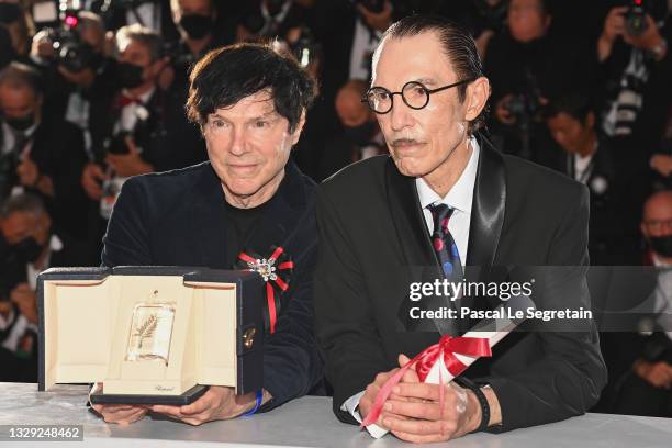 Russell Mael and Ron Mael pose with the 'Best Director Award' in the name of Leos Carax for 'Annette' during the 74th annual Cannes Film Festival on...