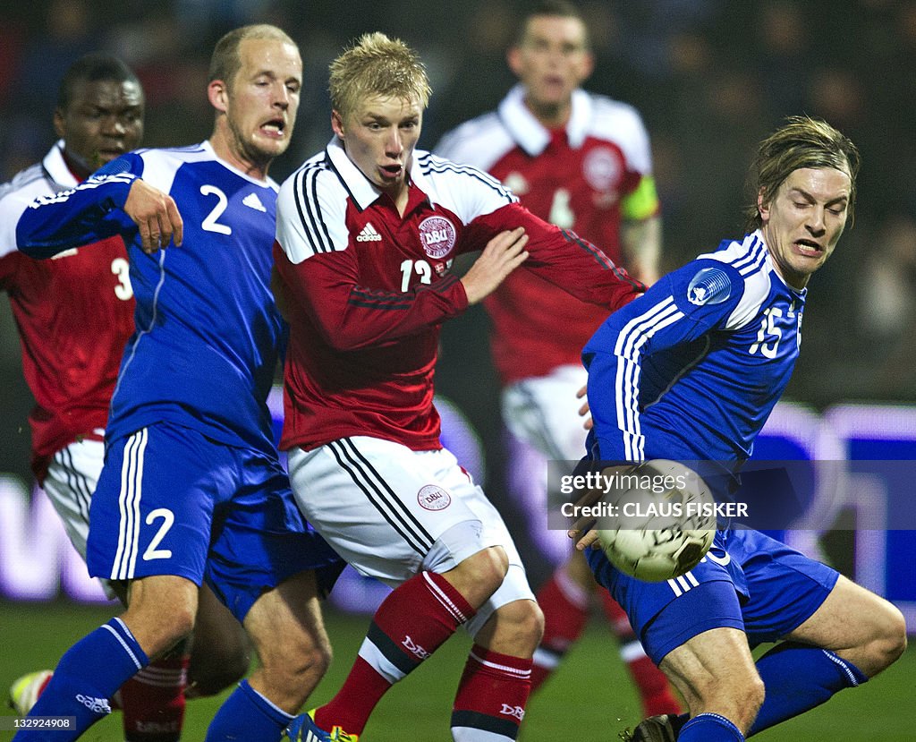 Daniel Wass of Denmark (C) vies for the