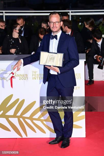 Juho Kuosmanen poses with the 'Grand Prix' Ex-Aequo for 'Hytti nro 6' during the 74th annual Cannes Film Festival on July 17, 2021 in Cannes, France.