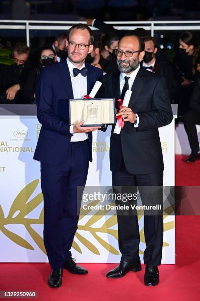 Juho Kuosmanen and Asghar Farhadi pose with the 'Grand Prix' Ex-Aequo for 'Hytti nro 6' and for 'A Hero' during the 74th annual Cannes Film Festival...
