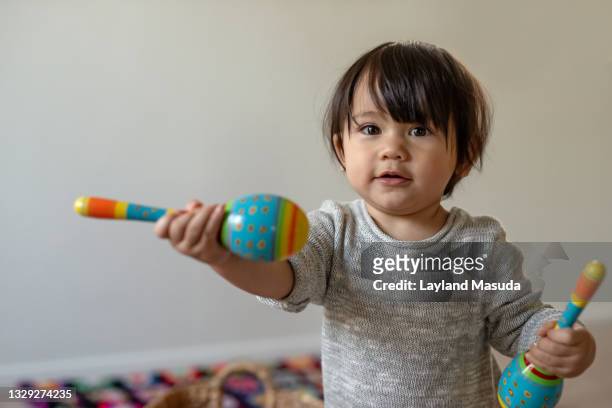 baby's maracas - toddler musical instrument stock pictures, royalty-free photos & images