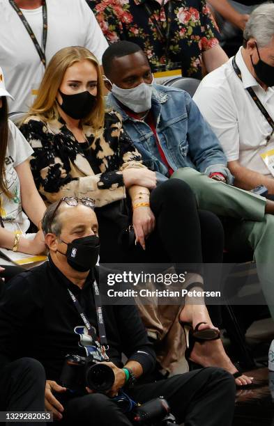 Singer Adele looks on next to Rich Paul during the first half in Game Five of the NBA Finals between the Milwaukee Bucks and the Phoenix Suns at...
