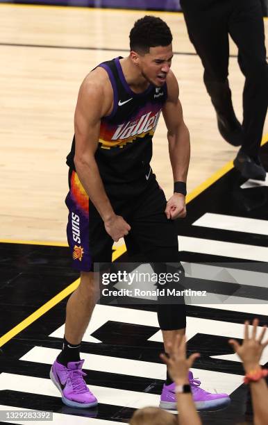 Devin Booker of the Phoenix Suns celebrates a dunk against the Milwaukee Bucks during the first half in Game Five of the NBA Finals at Footprint...