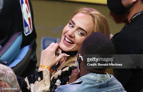 Singer Adele smiles with Rich Paul during the second half in Game Five of the NBA Finals between the Milwaukee Bucks and the Phoenix Suns at...