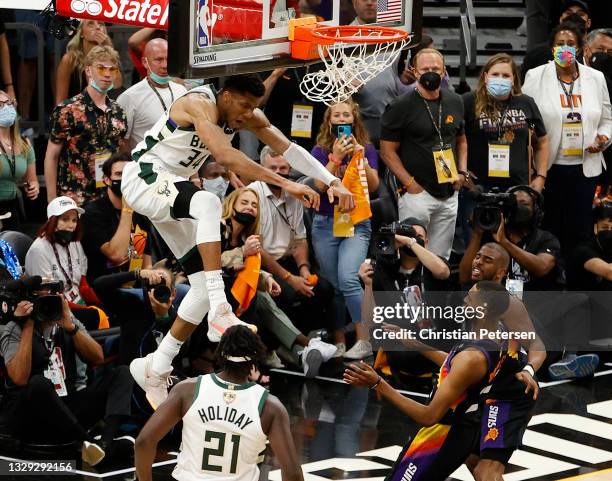 Giannis Antetokounmpo of the Milwaukee Bucks dunks against Chris Paul of the Phoenix Suns during the second half in Game Five of the NBA Finals at...