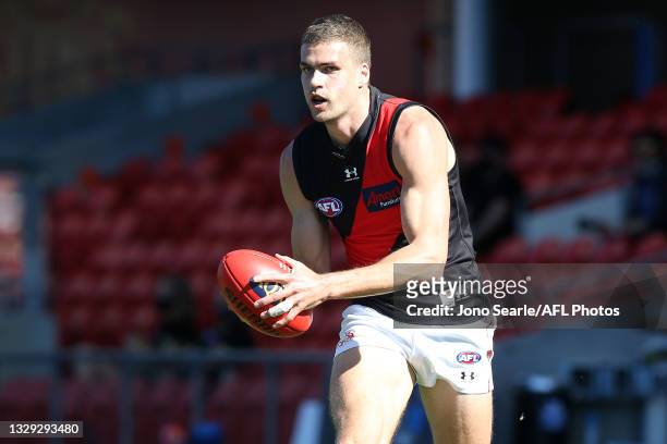 Tom Cutler of the Bombers makes a run during the round 18 AFL match between North Melbourne Kangaroos and Essendon Bombers at Metricon Stadium on...
