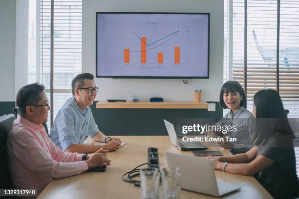 asian colleague having business meeting in conference room with television screen presentation with diagram chart forecasting - table numbers stockfoto's en -beelden
