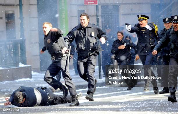 Filming of the Batman movie 'The Dark Knight Rises' at Wall Street & Williams St NYC. Matthew Modine fires away during a scene. But cops say that...