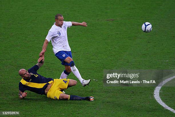 Daniel Majstorovic of Sweden tackles Bobby Zamora of England during the international friendly match between England and Sweden at Wembley Stadium on...