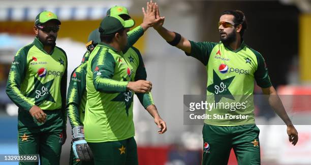 Pakistan bowler Imad Wasim celebrates with team mates after taking the wicket of Jason Roy during the Second Vitality Blast IT20 between England and...
