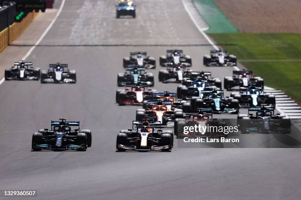 Lewis Hamilton of Great Britain driving the Mercedes AMG Petronas F1 Team Mercedes W12 and Max Verstappen of the Netherlands driving the Red Bull...