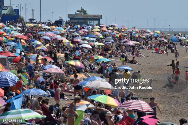 Crowds gather to enjoy the warm sunny weather on Jubilee beach on July 18, 2021 in Southend-on-Sea, England. A heat-heath warning has been issued for...