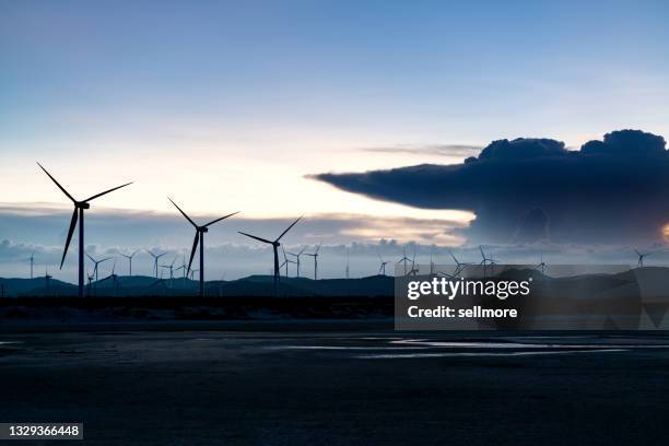 wind power plant in twilight - green economy stock-fotos und bilder