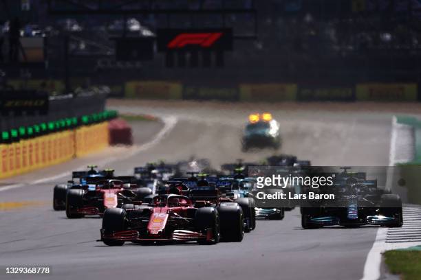 Charles Leclerc of Monaco driving the Scuderia Ferrari SF21 leads the field into turn one at the restart during the F1 Grand Prix of Great Britain at...