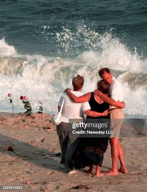 Relatives of victims from TWA Flight 800 console each other during a memorial service on July 17, 1997 at Smith Point Park, in Mastic Beach, New...