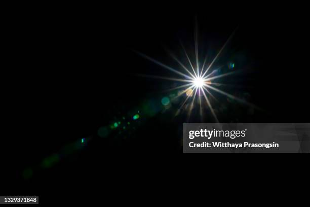 star with lens flare - zwarte achtergrond stockfoto's en -beelden