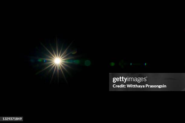lens flare on black background, solar energy, abstract, sun light. - glitter black background stockfoto's en -beelden