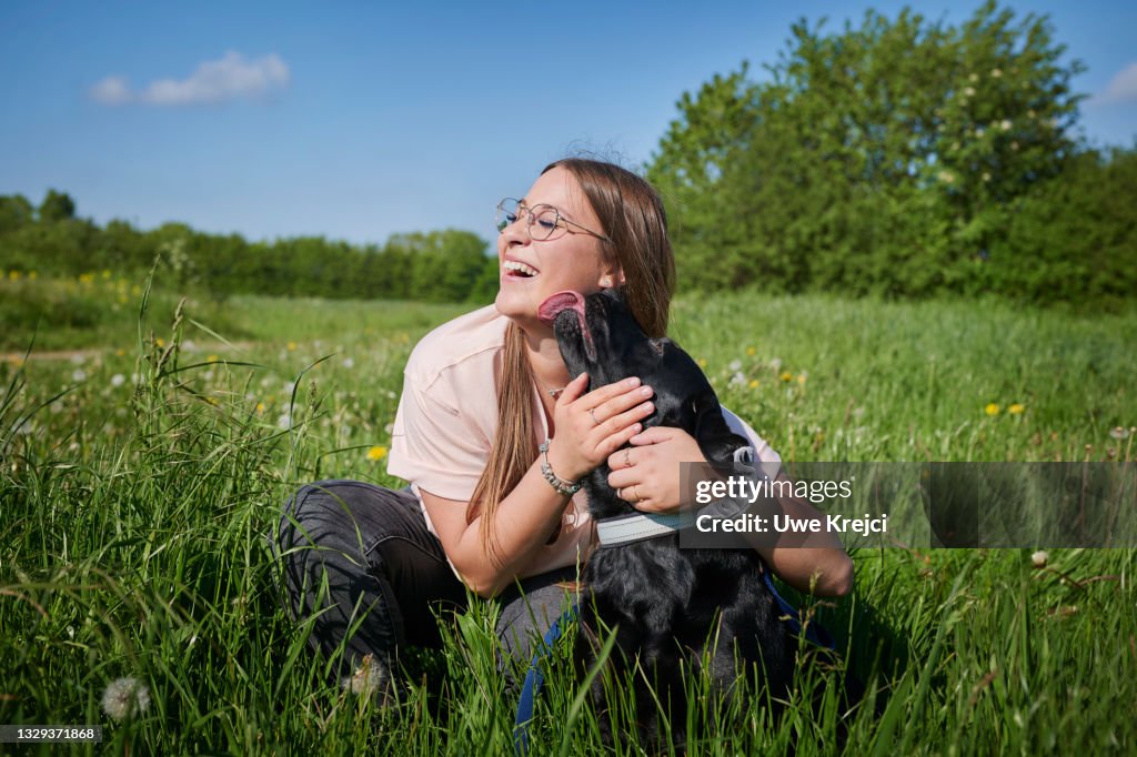 Young woman embracing pet dog