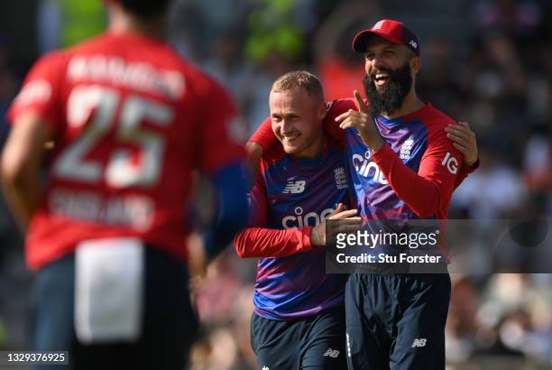England bowler Matt Parkinson is congratulated by Moeen Ali after taking the wicket of Azam Khan during the Second Vitality Blast IT20 between...