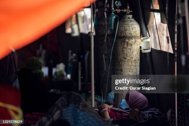 Covid19 patients get treatment in an emergency tent at Bekasi General Hospital on July 18, 2021 in Bekasi, Indonesia. Indonesia has imposed emergency...