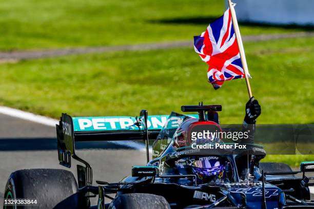 Lewis Hamilton of Mercedes and Great Britain celebrates winning during the F1 Grand Prix of Great Britain at Silverstone on July 18, 2021 in...