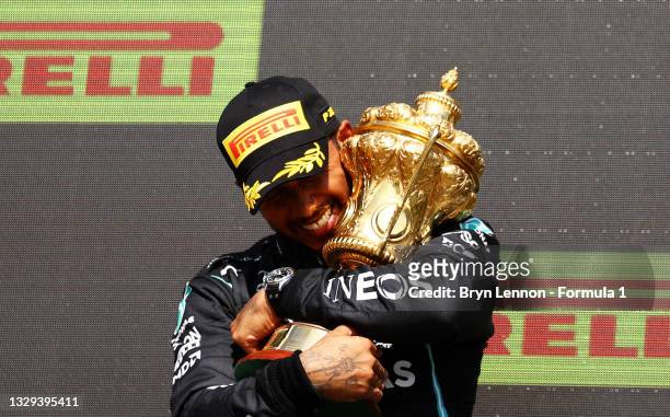Race winner Lewis Hamilton of Great Britain and Mercedes GP celebrates on the podium during the F1 Grand Prix of Great Britain at Silverstone on July...
