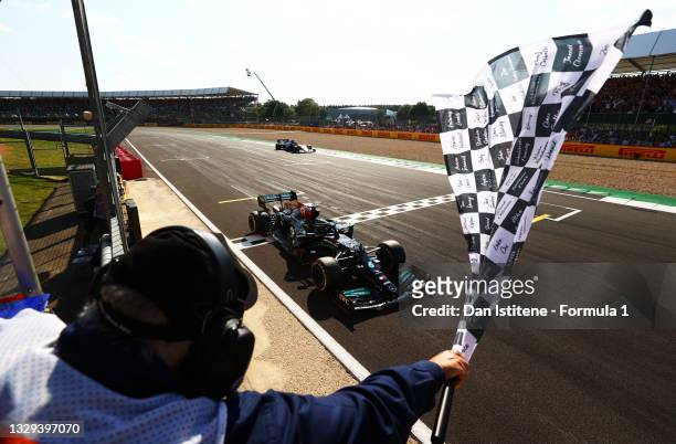 Race winner Lewis Hamilton of Great Britain driving the Mercedes AMG Petronas F1 Team Mercedes W12 takes the chequered flag during the F1 Grand Prix...