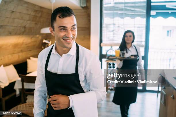 beautiful young waiter at work - hotel reopening stock pictures, royalty-free photos & images