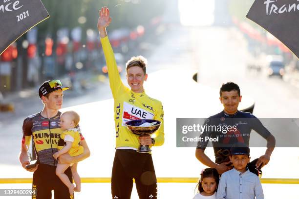 Jonas Vingegaard of Denmark and Team Jumbo-Visma and his daughter Frida, Tadej Pogačar of Slovenia and UAE-Team Emirates Yellow Leader Jersey &...