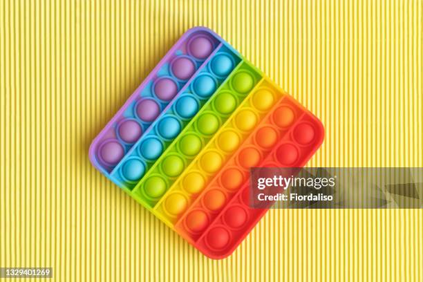 pop it antistress toy push the rubber bubbles - push pop fidget toy stock pictures, royalty-free photos & images