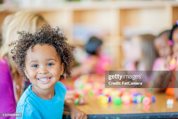 preschool kid enjoying himself - daycare stock pictures, royalty-free photos & images