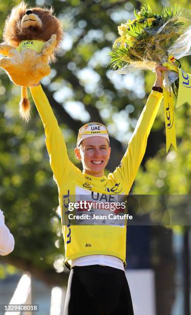 Race winner's Yellow Jersey Tadej Pogacar of Slovenia and UAE Team Emirates celebrates during the trophy ceremony of final stage 21 of the 108th Tour...