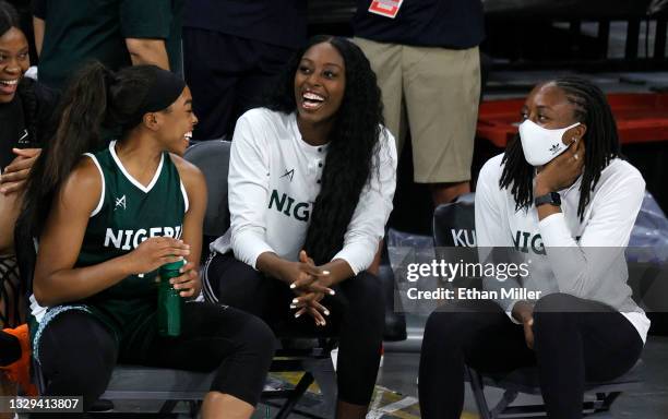 Erica Ogwumike, Chiney Ogwumike and Nneka Ogwumike of Nigeria look on from the bench during an exhibition game against the United States at Michelob...