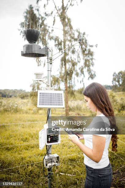 woman checking weather station - weather station stock pictures, royalty-free photos & images