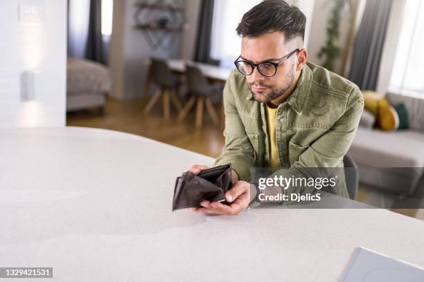 worried young man having financial problems. - stealing wallet stock pictures, royalty-free photos & images