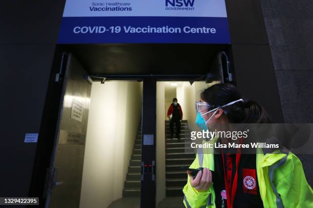 St John Ambulance staff member directs clients at a COVID-19 Vaccination Centre in the CBD on July 19, 2021 in Sydney, Australia. Lockdown...