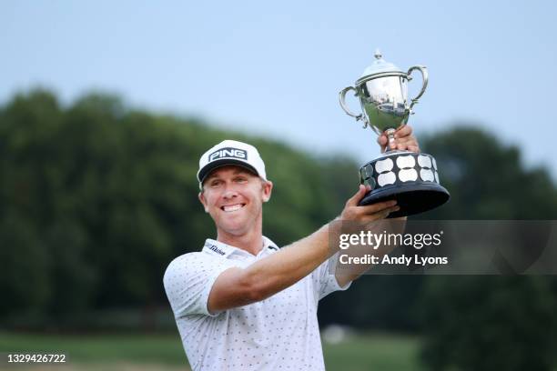 Seamus Power of Ireland poses with the trophy after putting in to win on the 18th hole during the sixth playoff hole during the final round of the...