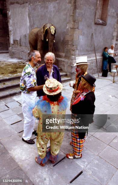 Chilean-French filmmaker and artist Alejandro Jodorowsky talks with clowns on the set before filming a scene during the 1989 drama film "Santa...
