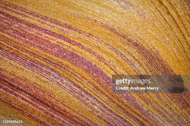 sandstone pattern, layered yellow red stone, close up - strato foto e immagini stock