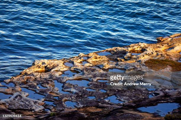 sea waves, sunlight on rocky coastline at dusk, australia - sandstone stock pictures, royalty-free photos & images