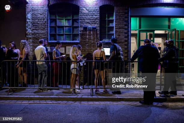 People queue to get in to the Egg London nightclub in the early hours of July 19, 2021 in London, England. As of 12:01 on Monday, July 19, England...