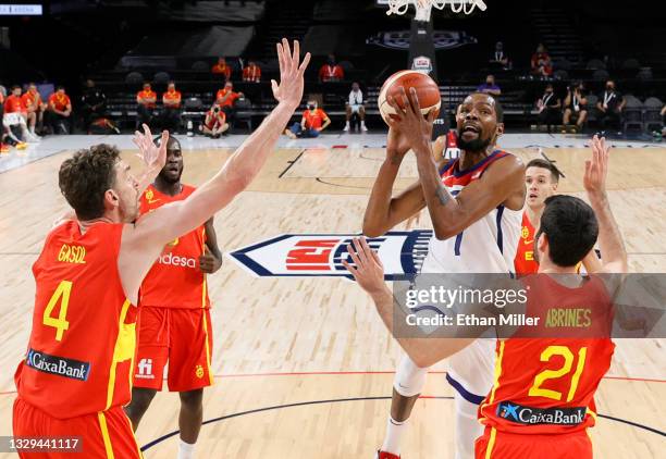 Kevin Durant of the United States drives to the basket against Alex Abrines and Pau Gasol of Spain during an exhibition game at Michelob ULTRA Arena...