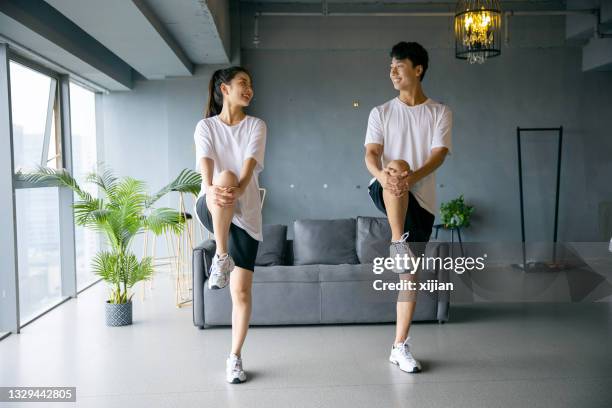 young couple exercising together - japanese ethnicity the human body stock pictures, royalty-free photos & images