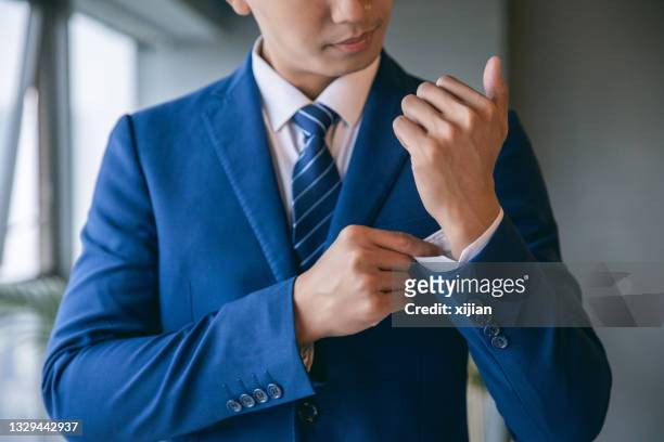 businessman dressing himself - menswear stock pictures, royalty-free photos & images
