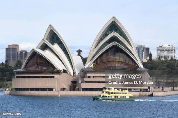 Sydney ferry passes the Opera House on July 19, 2021 in Sydney, Australia. Lockdown restrictions have been further tightened as NSW continues to...