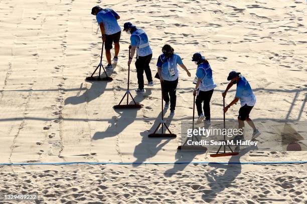 Workers prepare the Beach Volleyball court prior to a training session at Shiokaze Park on July 19, 2021 in Tokyo, Japan.