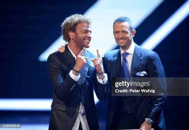 Rufus Martin celebrates with Till Broenner during 'The X Factor Live' TV-Show on November 15, 2011 in Cologne, Germany.