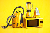 Yellow household appliances on yellow background. Set of home  technics.