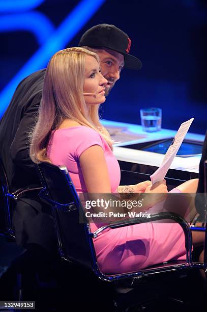 Jury members Mirko Bogojevic and Sarah Connor listen to a performance during 'The X Factor Live' TV-Show on November 15, 2011 in Cologne, Germany.