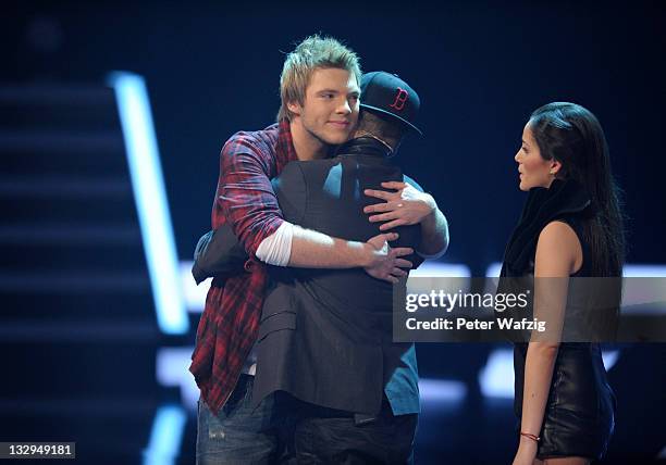 Jury member Mirko Bogojevic hugs Martin Madeja who has to quit the contest during 'The X Factor Live' TV-Show on November 15, 2011 in Cologne,...